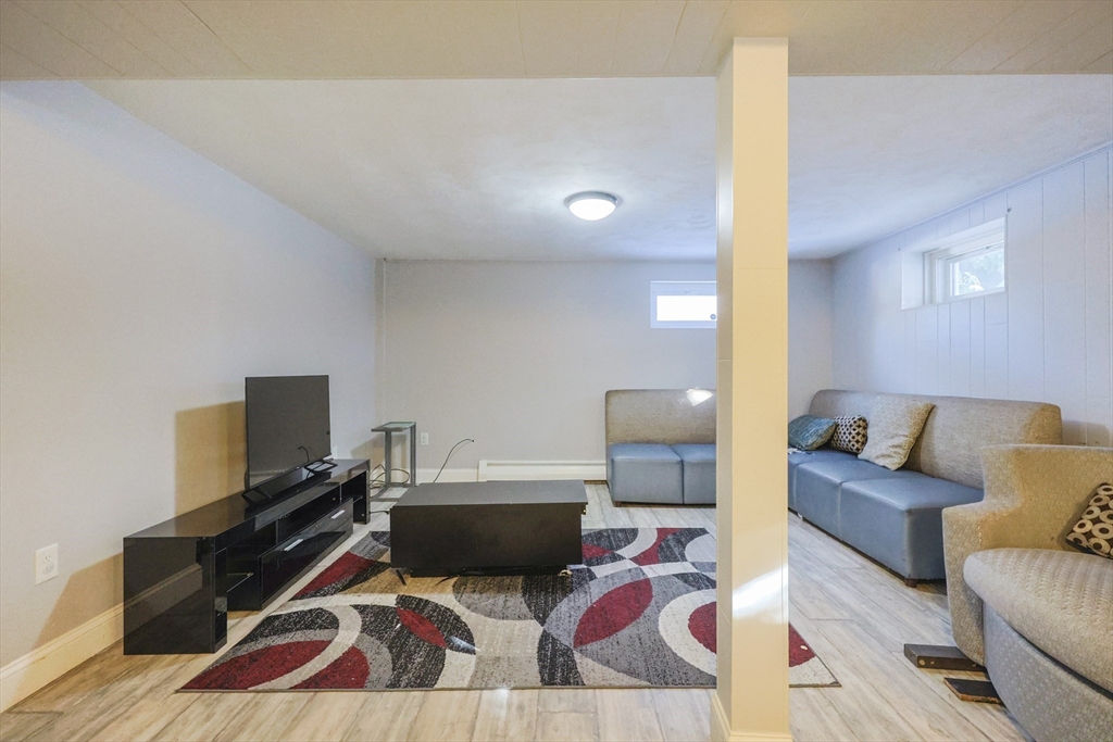 128 Salem Road Billerica, MA 01821 - Photo 36 of 42 a living room with furniture and a flat screen tv