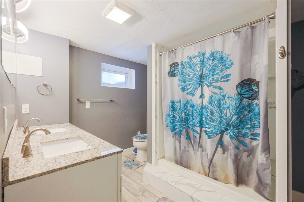 128 Salem Road Billerica, MA 01821 - Photo 38 of 42 a bathroom with a granite countertop sink and a mirror