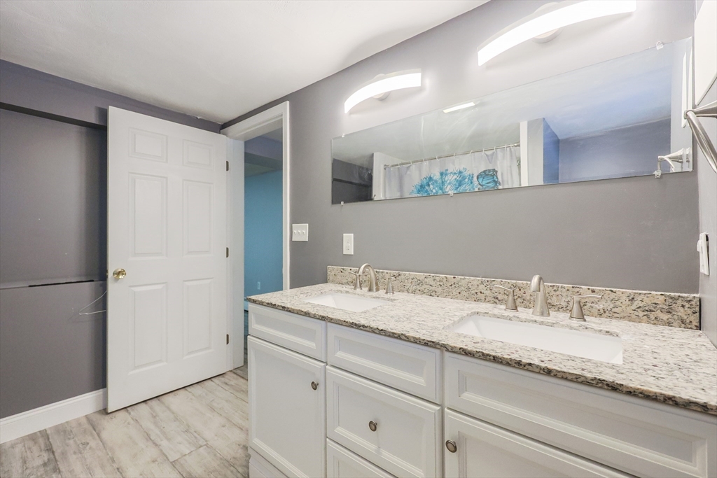 128 Salem Road Billerica, MA 01821 - Photo 39 of 42 a bathroom with a granite countertop sink and a mirror