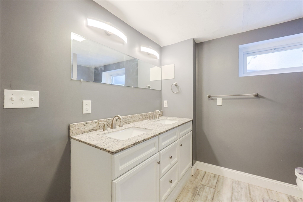 128 Salem Road Billerica, MA 01821 - Photo 40 of 42 a bathroom with a granite countertop sink and a mirror