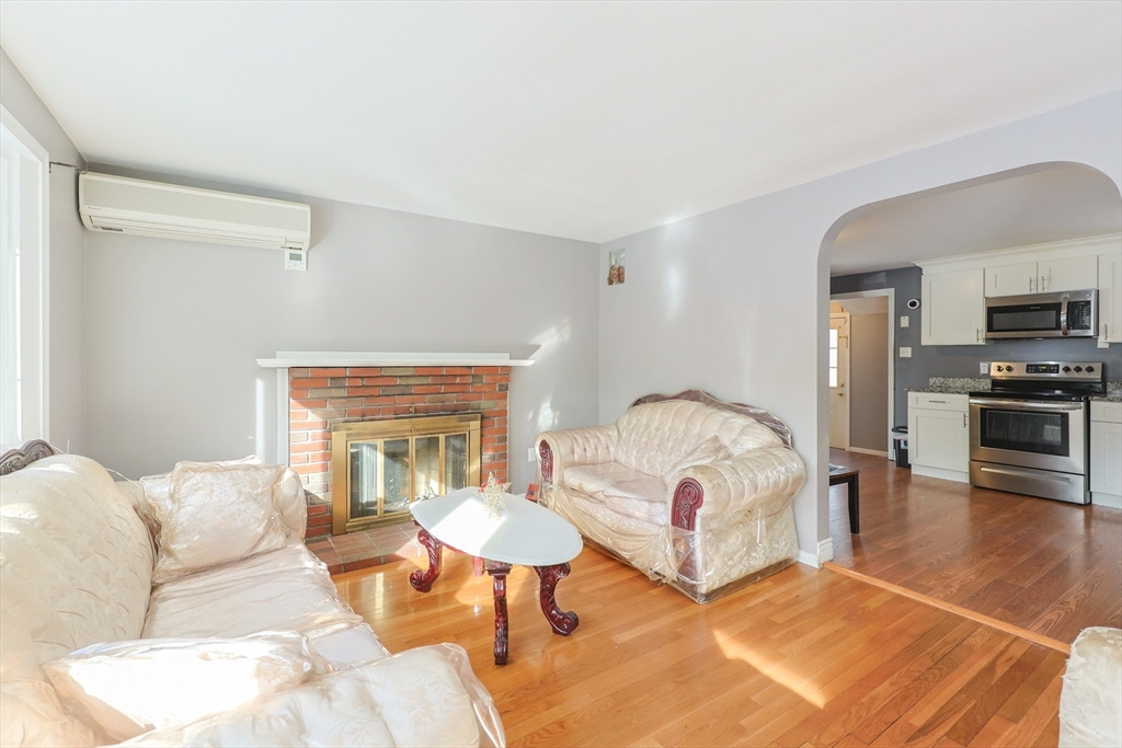 128 Salem Road Billerica, MA 01821 - Photo 4 of 42 a living room with furniture and a fireplace