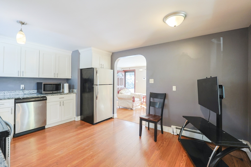 128 Salem Road Billerica, MA 01821 - Photo 9 of 42 a kitchen with a refrigerator and a stove top oven