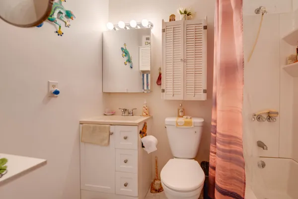 a bathroom with a toilet a sink and a window