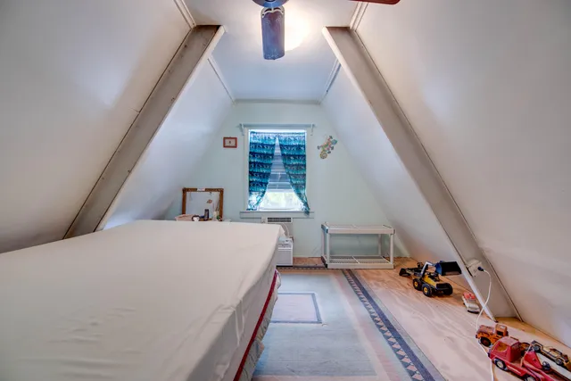 a bed room with a bed and a large window