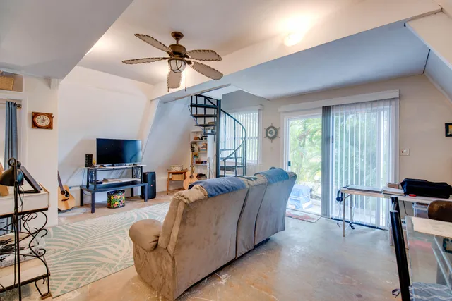 a living room with furniture and a flat screen tv with wooden floor