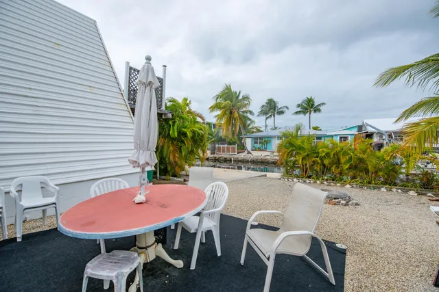 a view of a chairs and table in patio
