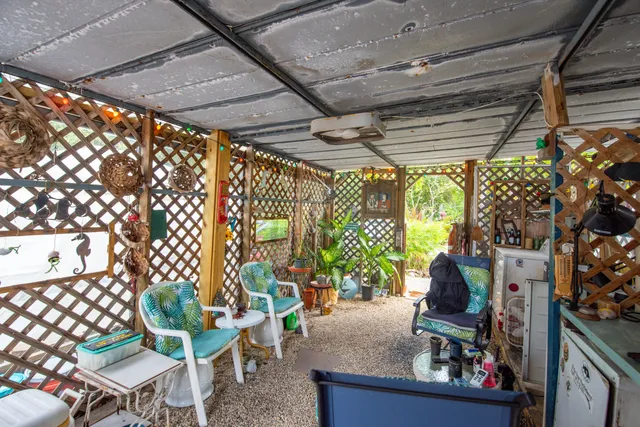 a room with lots of furniture and potted plants