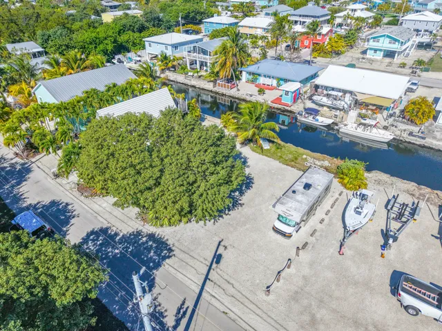 an aerial view of a house a yard and lake view