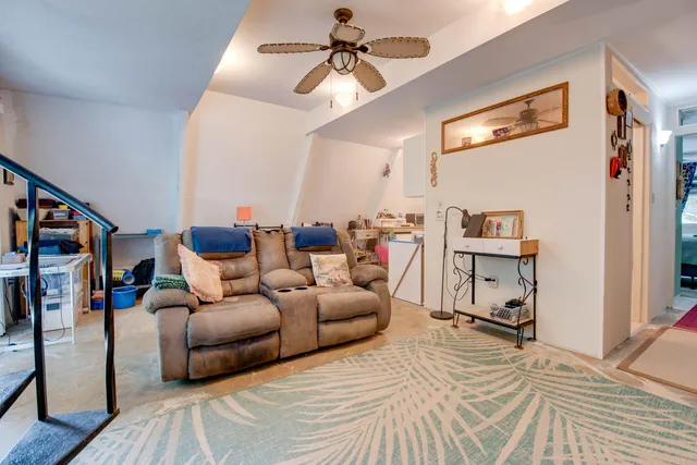 a bedroom with furniture and a ceiling fan