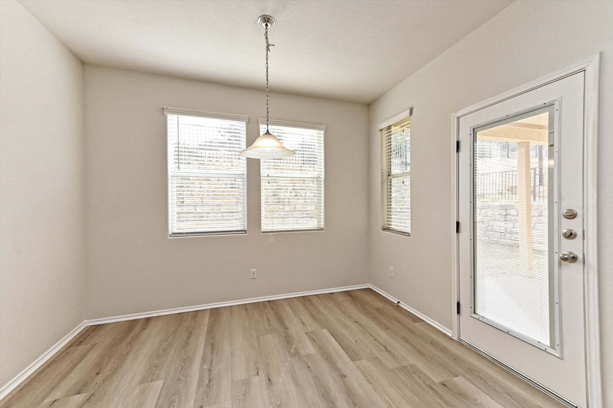 31 Stone Terrace Drive Austin, TX 78734 - Photo 12 of 29 Unfurnished dining area with light wood-style floors and baseboards