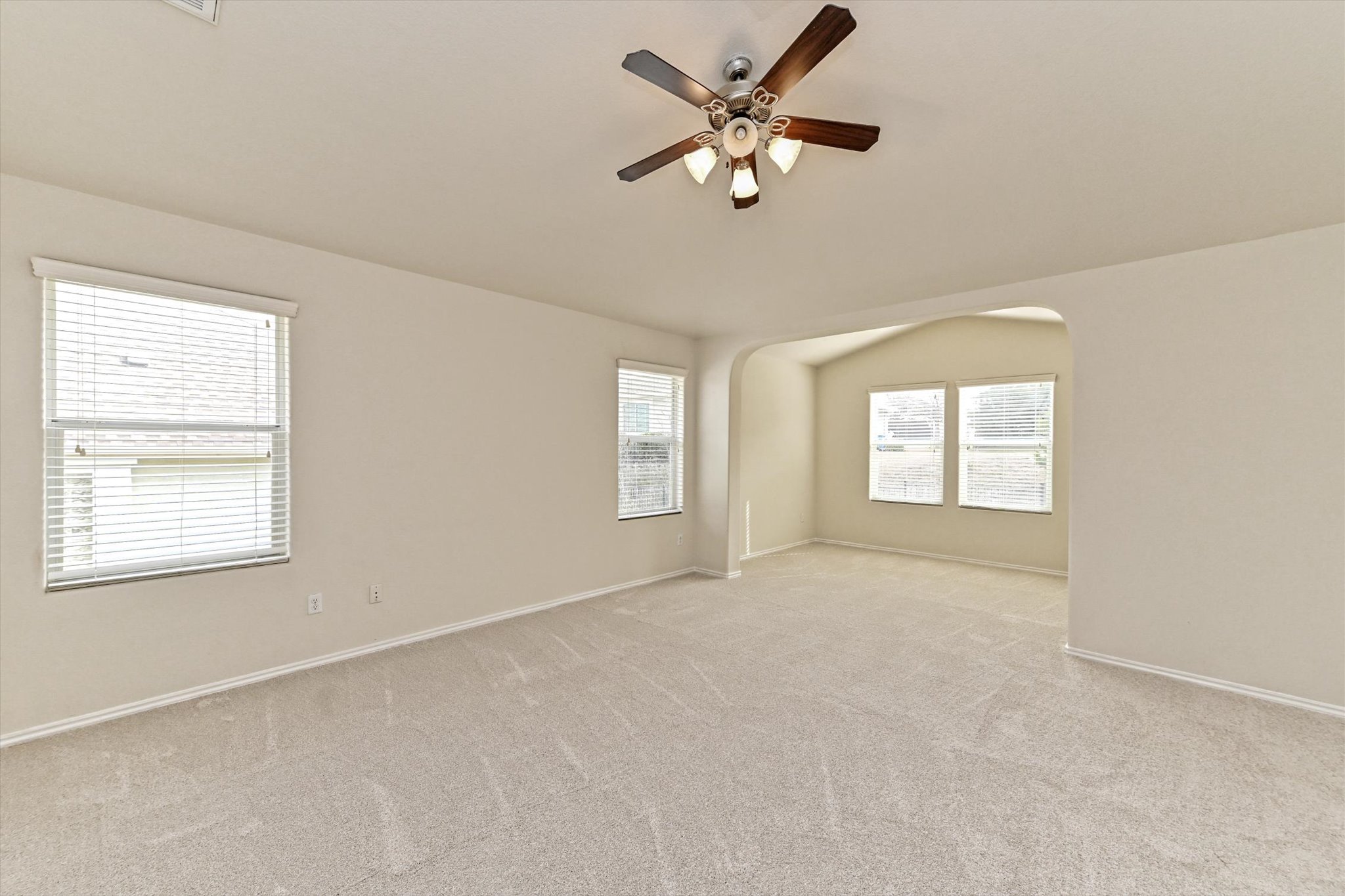 31 Stone Terrace Drive Austin, TX 78734 - Photo 17 of 29 Empty room with carpet, a ceiling fan, lofted ceiling, and arched walkways