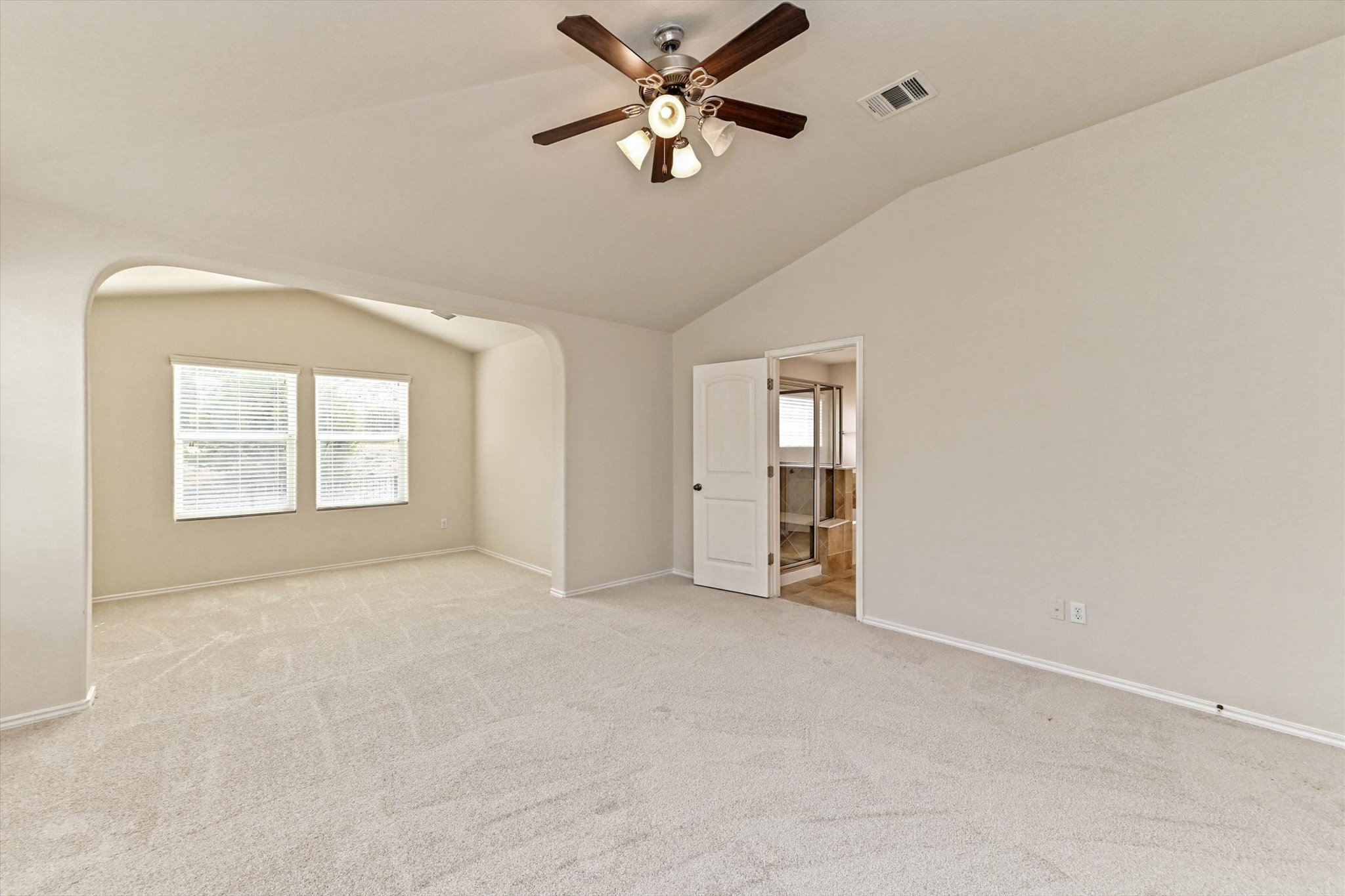 31 Stone Terrace Drive Austin, TX 78734 - Photo 18 of 29 Unfurnished bedroom featuring lofted ceiling, carpet, multiple windows, and a ceiling fan