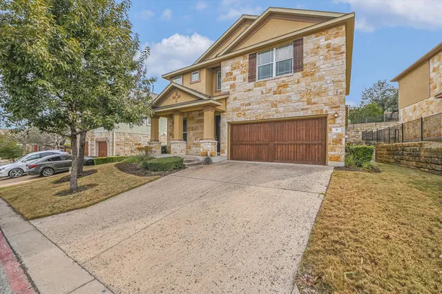 a front view of a house with a yard and garage