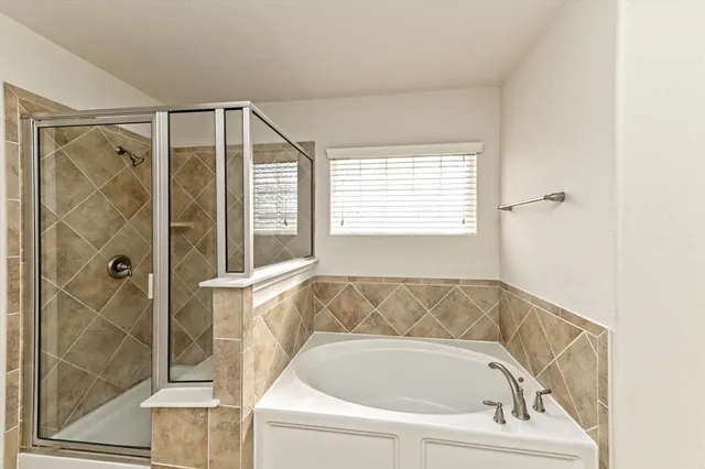 a bathroom with a bathtub and a shower