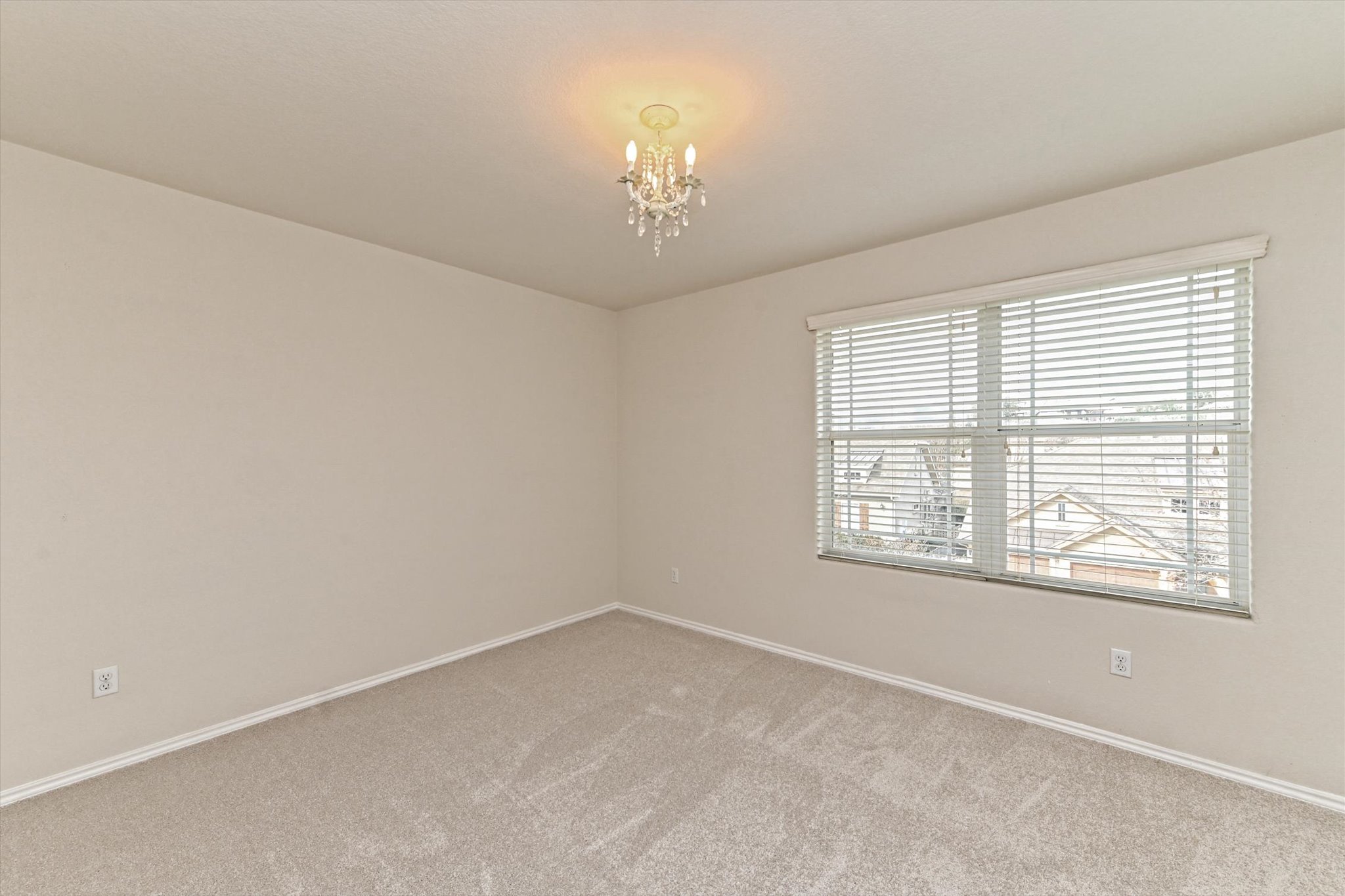31 Stone Terrace Drive Austin, TX 78734 - Photo 25 of 29 Empty room with carpet and hanging lights