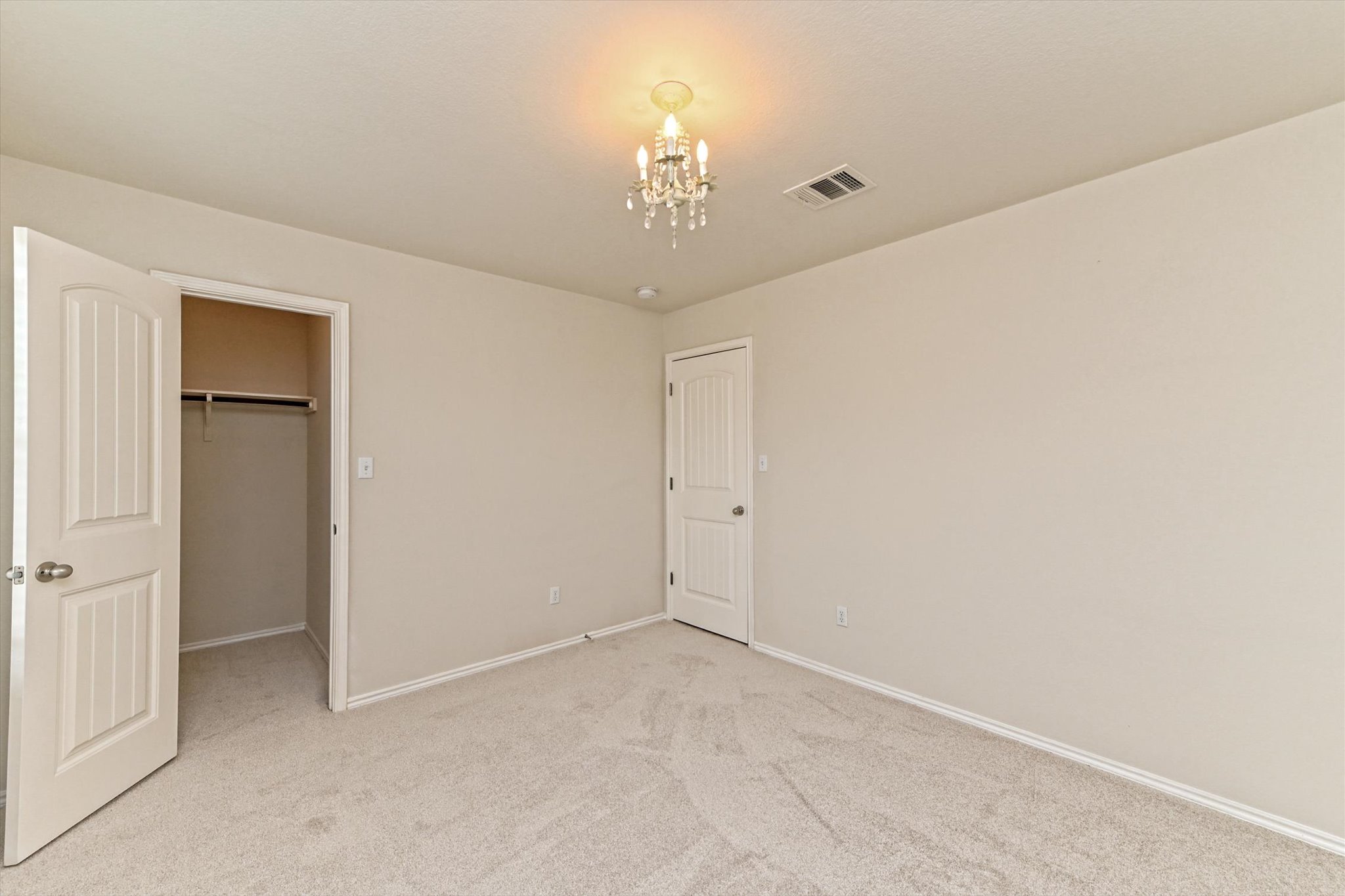 31 Stone Terrace Drive Austin, TX 78734 - Photo 26 of 29 Unfurnished bedroom with a spacious closet, carpet, and suspended lighting