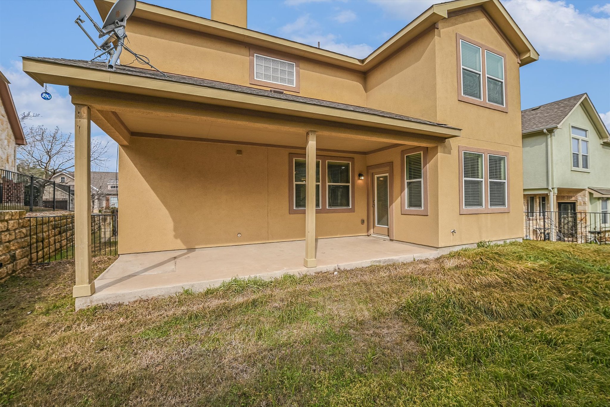 31 Stone Terrace Drive Austin, TX 78734 - Photo 28 of 29 Rear view of house with a patio area, stucco siding, and a chimney