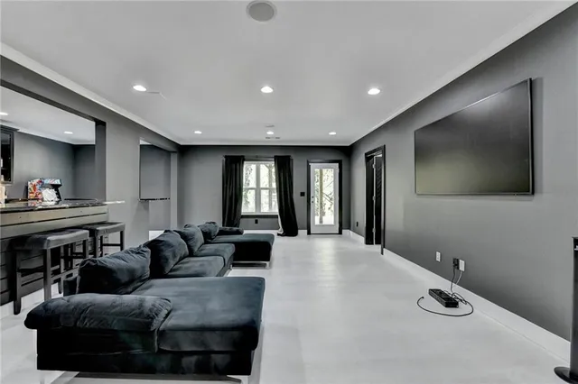 a view of a brick house with large windows and a yard