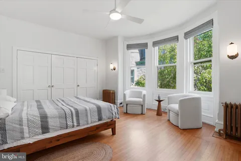 a bedroom with bed and a large window