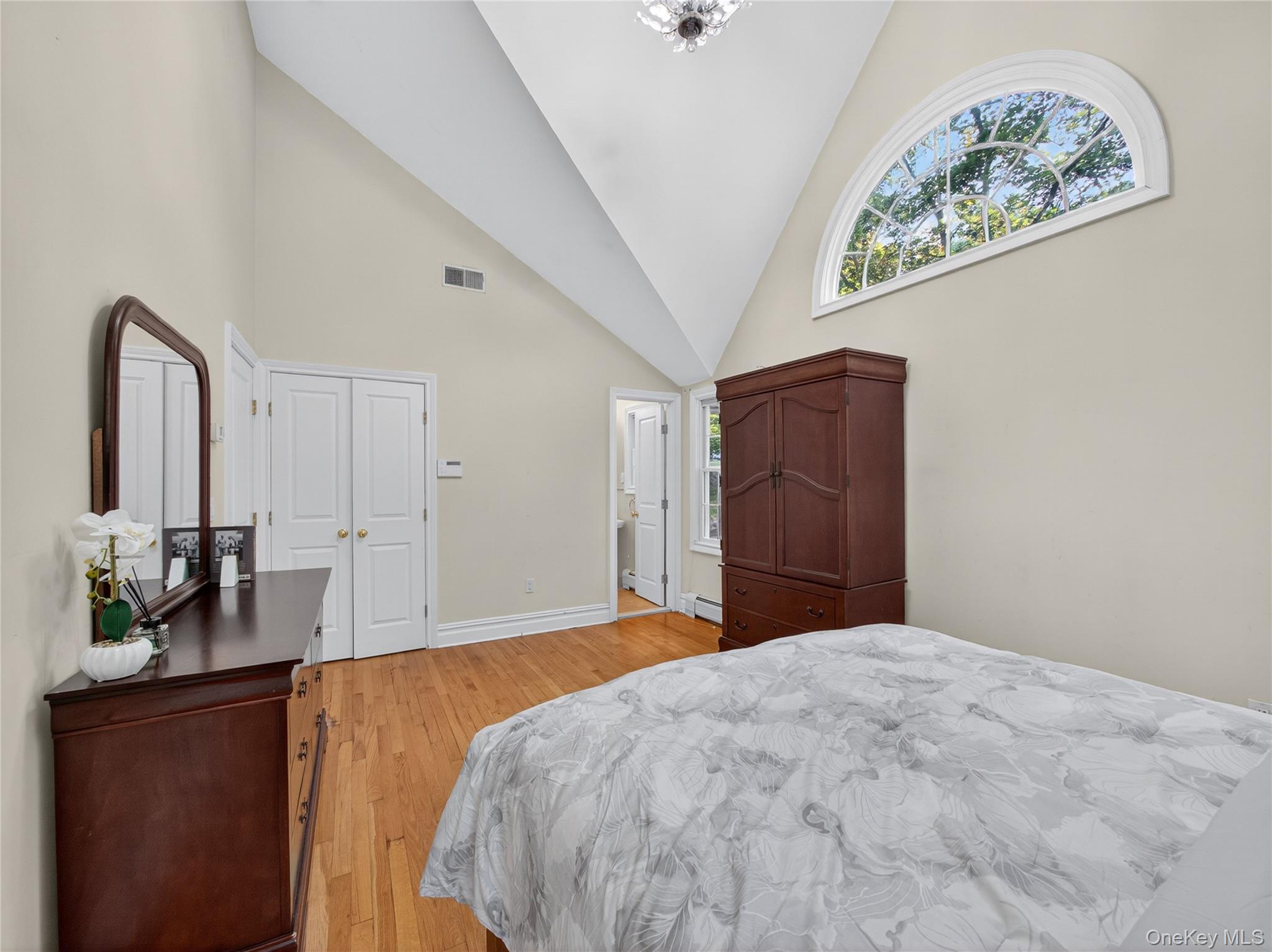 516 Oak Tree Road Palisades, NY 10964 - Photo 28 of 38 a bedroom with a large bed and a chandelier