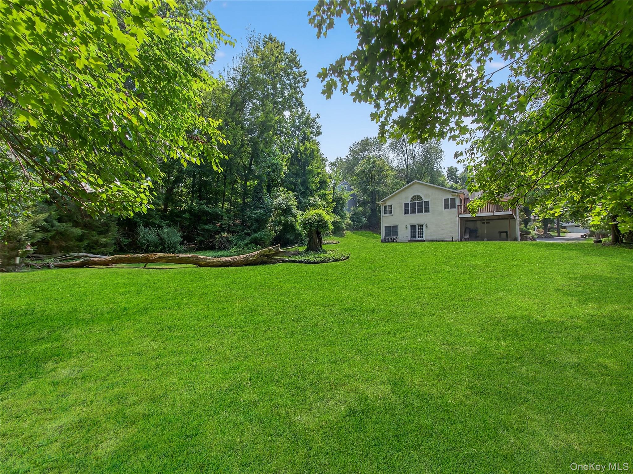 516 Oak Tree Road Palisades, NY 10964 - Photo 34 of 38 a view of a green field with trees in the background