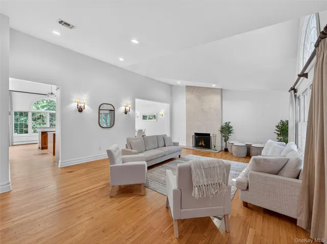 a living room with fireplace furniture and a wooden floor