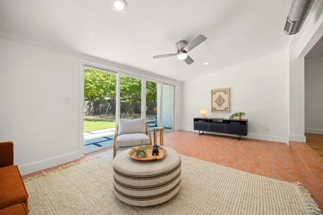 a living room with furniture and a floor to ceiling window