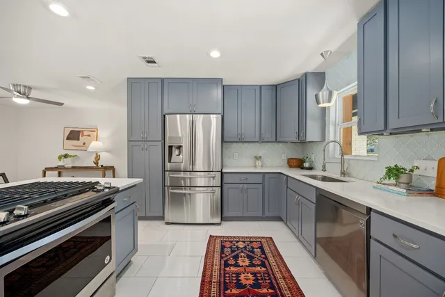 a kitchen with a stove and a refrigerator