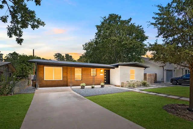 a front view of house with yard and outdoor seating