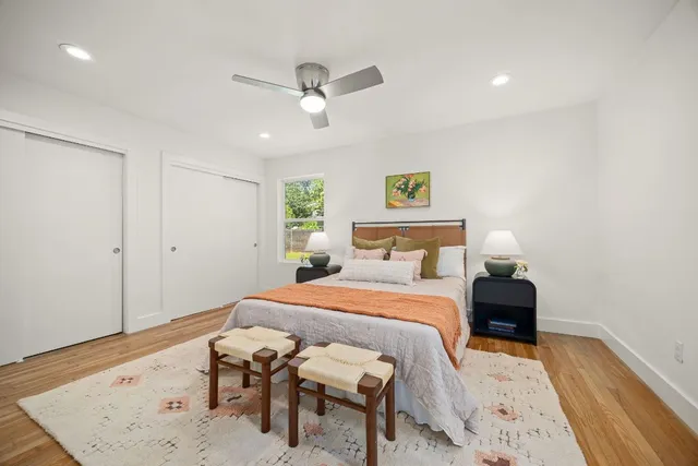 a bedroom with a bed and wooden floor
