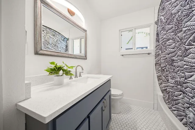 a bathroom with a sink mirror vanity and toilet