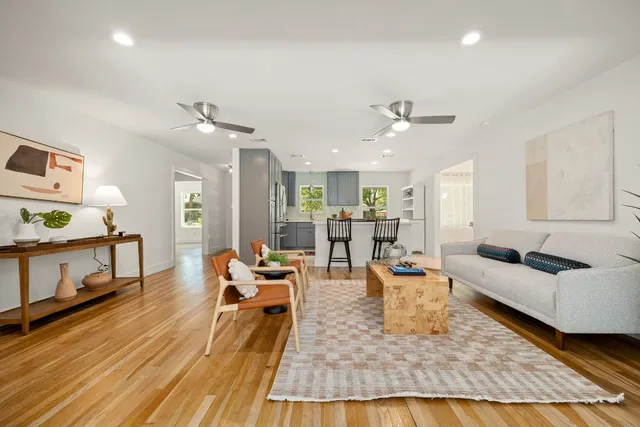 a living room with furniture and a wooden floor