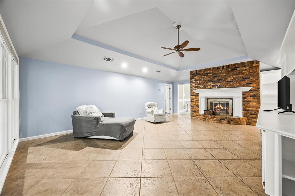 909 Valley View Avenue Red Oak, TX 75154 - Photo 18 of 37 a living room with furniture a fireplace and a flat screen tv