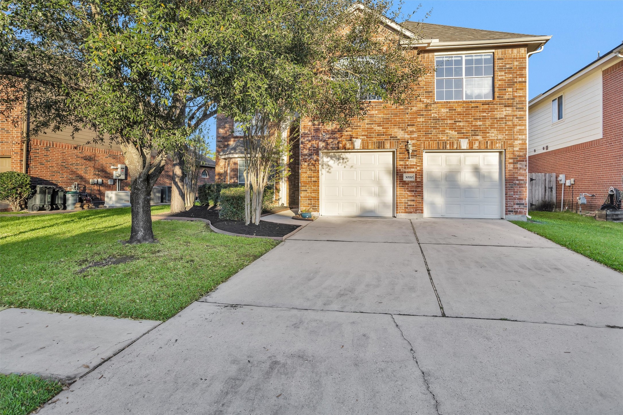 30110 Legends Ridge Drive Spring, TX 77386 - Photo 6 of 49 a front view of a house with a yard and trees