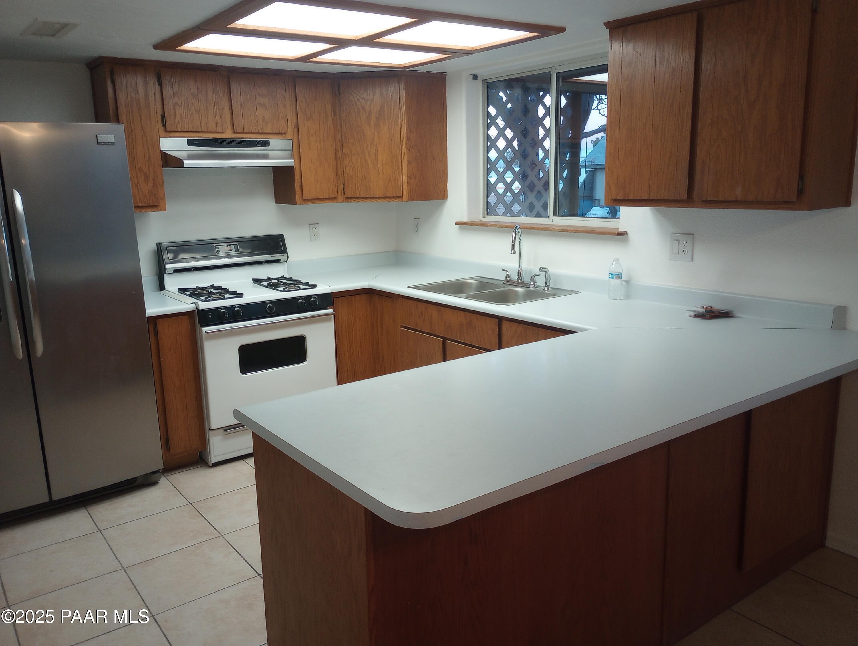 3325 Gopher Drive Chino Valley, AZ 86323 - Photo 4 of 19 a kitchen with a stove a sink and a refrigerator