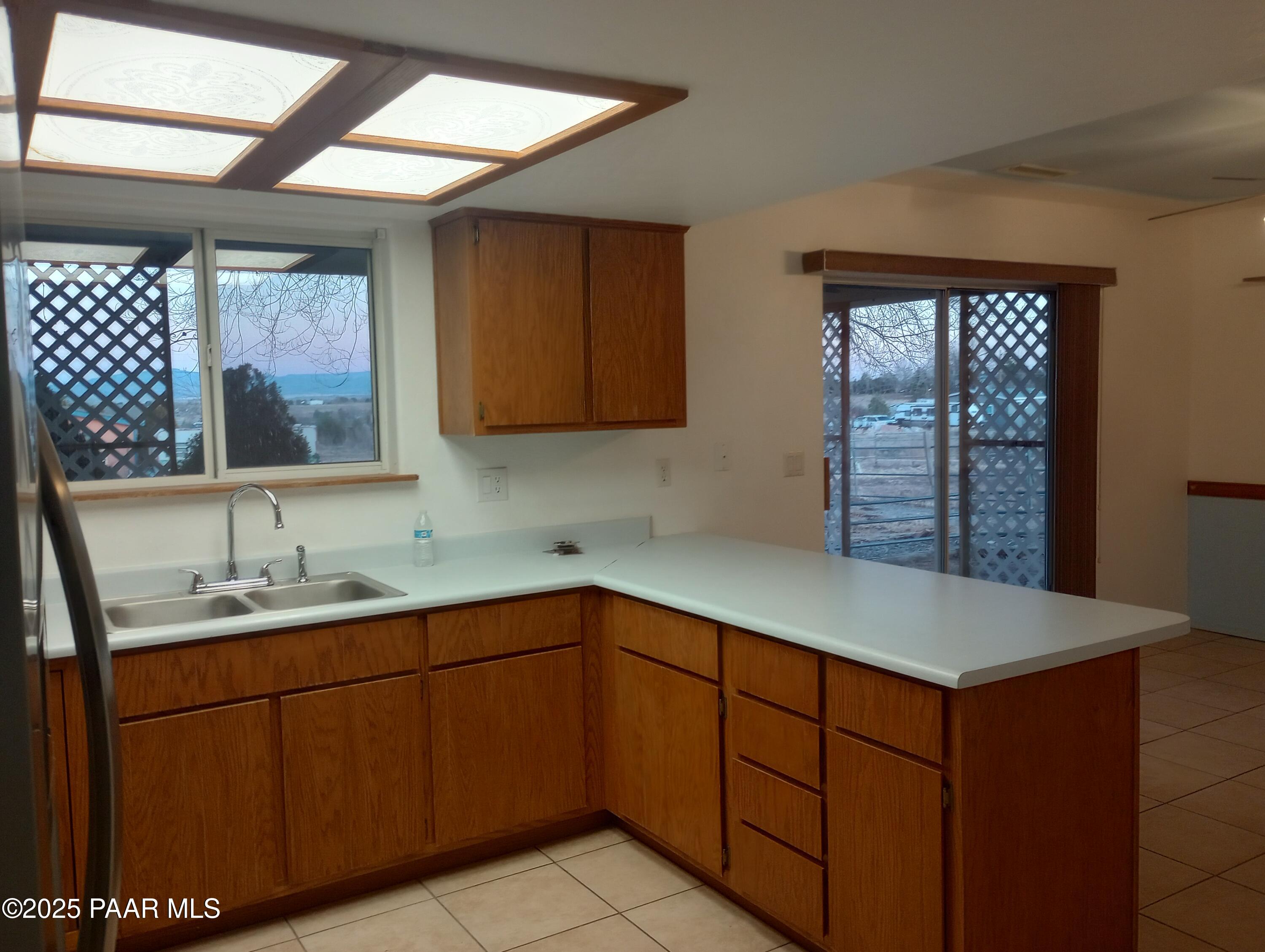 3325 Gopher Drive Chino Valley, AZ 86323 - Photo 5 of 19 a kitchen with a sink window and cabinets
