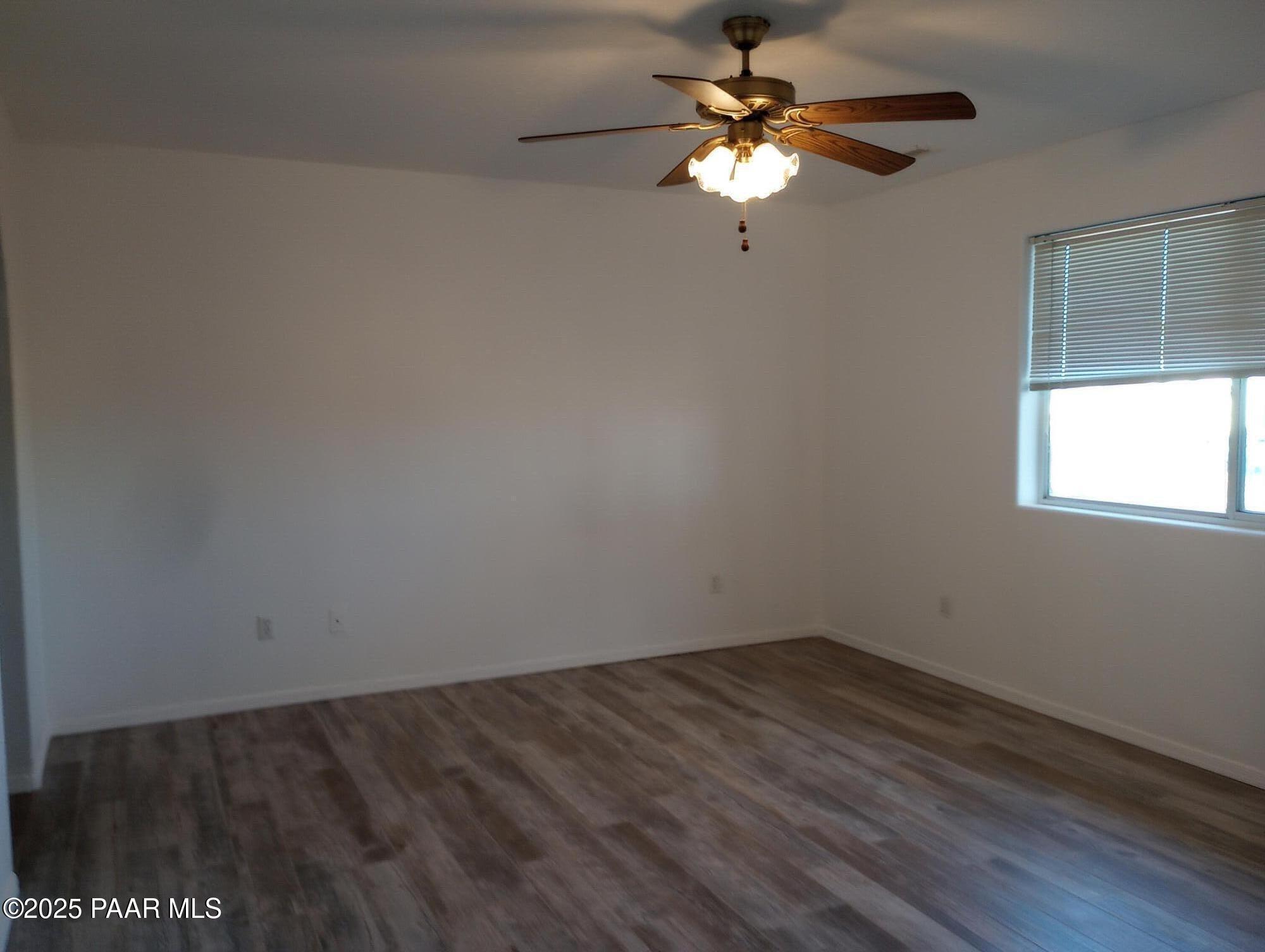 3325 Gopher Drive Chino Valley, AZ 86323 - Photo 7 of 19 a view of a workspace with wooden floor and a chandelier fan