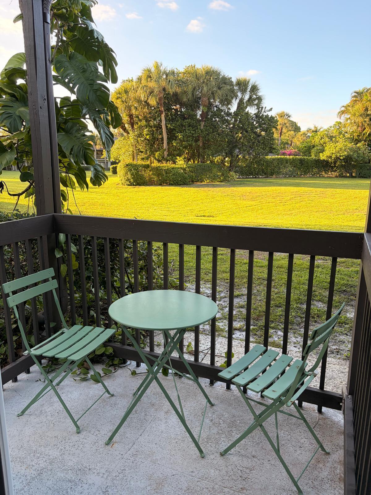 13334 Polo Club Road, Unit 216 Wellington, FL 33414 - Photo 4 of 9 a view of a chairs and table in patio