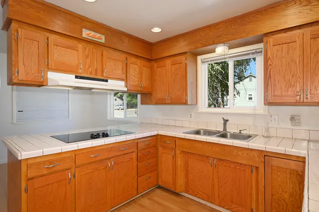 a kitchen with sink cabinets and window
