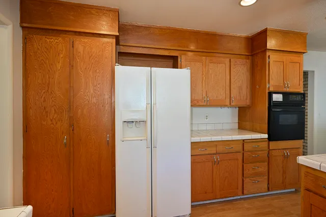 a kitchen with a refrigerator and cabinets