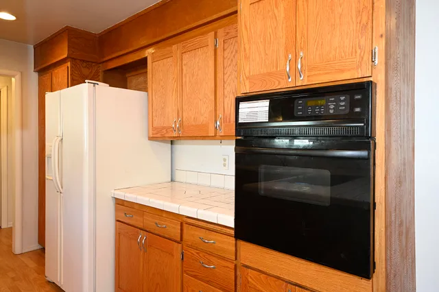 a kitchen with stainless steel appliances granite countertop a refrigerator and a stove
