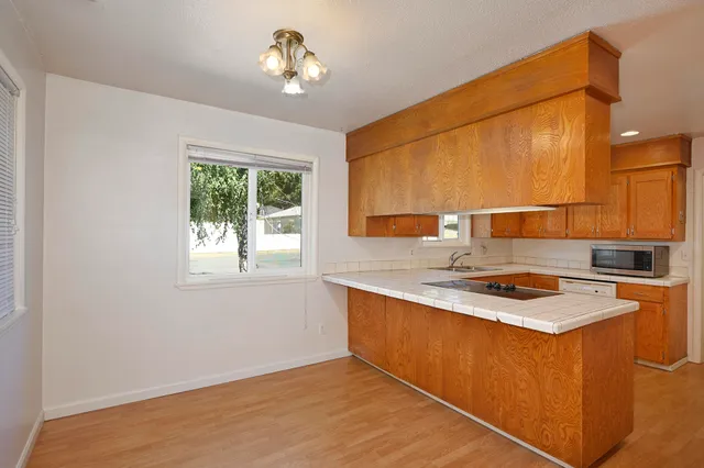 a kitchen with a stove a sink and a refrigerator