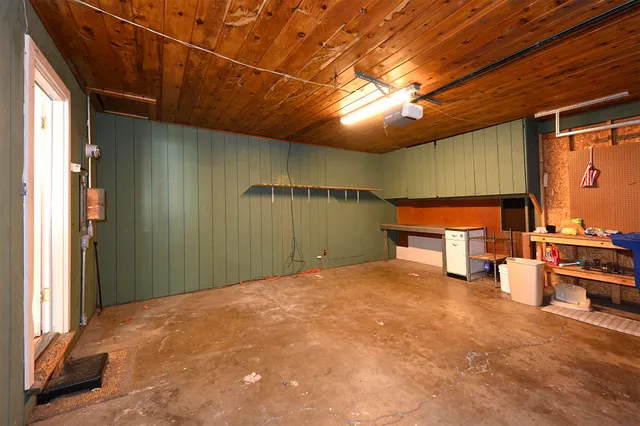 an empty room with windows and entrance