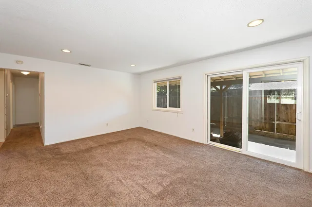 a view of empty room with a fireplace