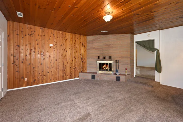 a view of an empty room with a fireplace