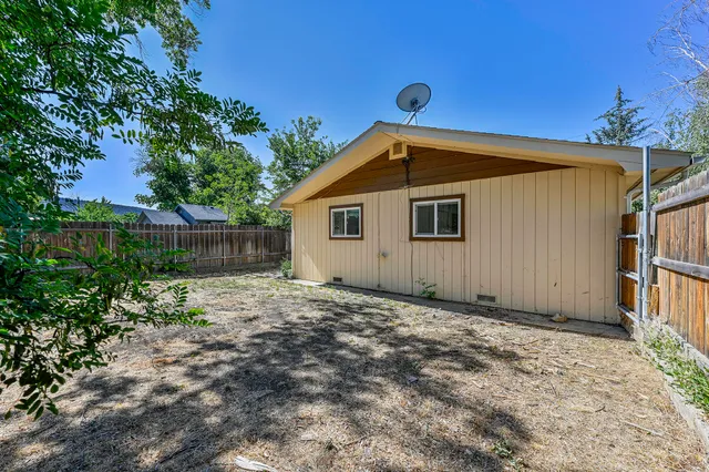 a backyard of a house with a tree
