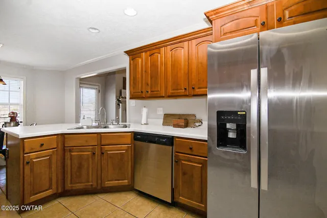 a kitchen with a sink refrigerator and cabinets