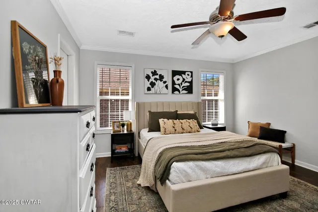 a bedroom with a bed and a painting on the wall