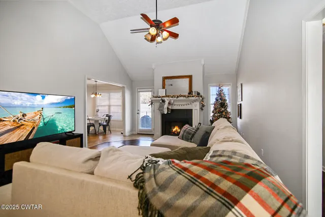 a living room with furniture a fireplace and a flat screen tv