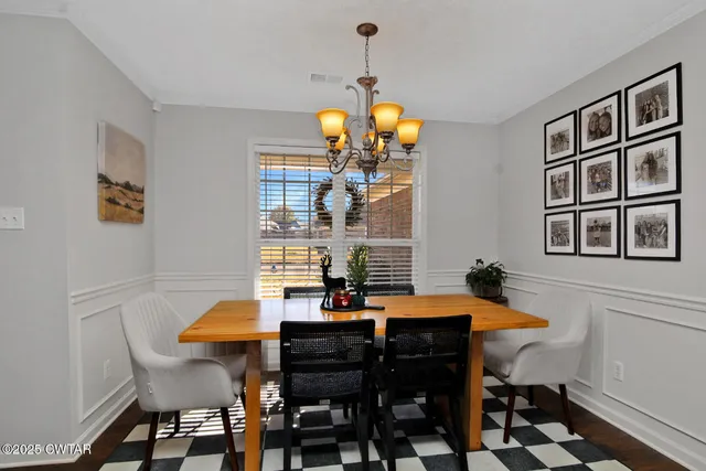 a view of a dining room with a table and chairs